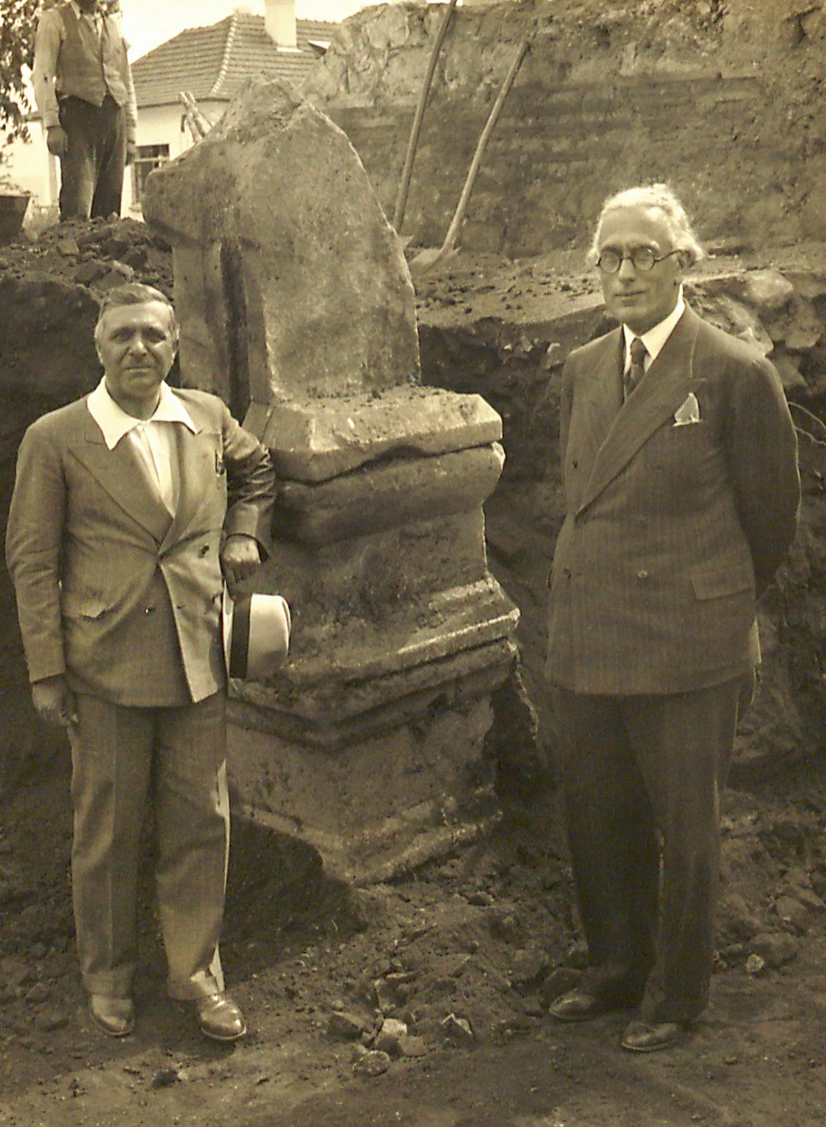 Aziz Ogan with a foreign archeologist, standing on a sarcophagus